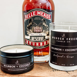 Bourbon + Coconut candle and bourbon on a wooden table