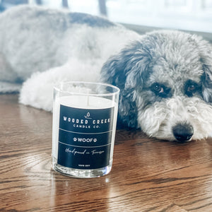 "Woof" product image showing a dog lying near a candle
