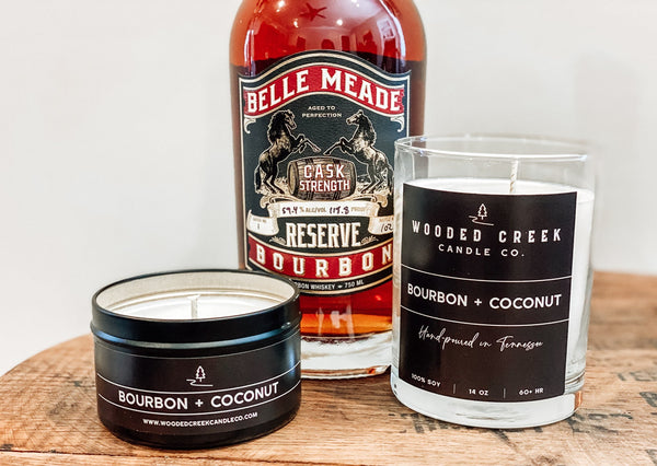 Bourbon + Coconut candle and bourbon on a wooden table