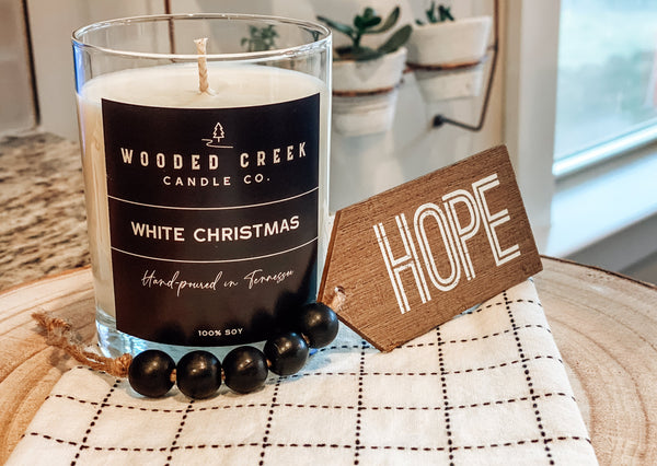 White Christmas product image featuring a candle with hope sign